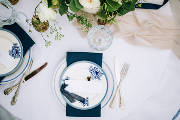 close-up of flowers that stand on the background of a served table in blue tones