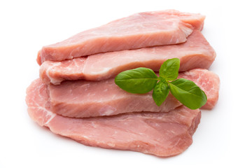 Fresh pork fillet with basil on a white background.