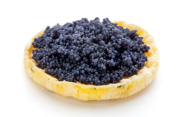 Canapes with black sturgeon caviar on the isolated white background.