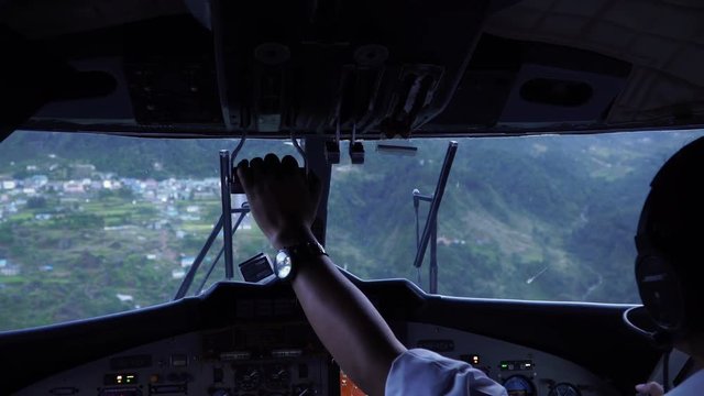 Landing aircraft at Tenzing-Hillary Airport in Lukla. Cockpit view of plane landing. The airport in Lukla is the most dangerous airport in the world.