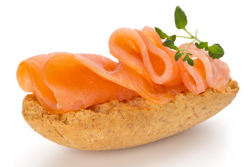 Bread with fresh salmon fillet isolated on white background, top view.