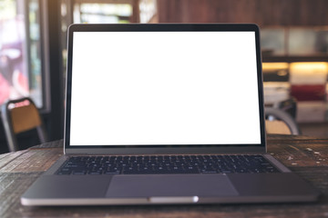 Mockup image of laptop with blank white desktop screen on wooden table in modern cafe