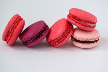 multicolored macarons on a white background