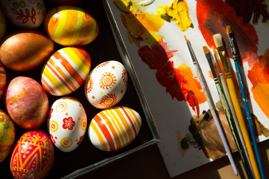 Easter eggs, brushes and paints