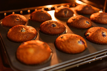 home muffins with forest berries are baked in the oven