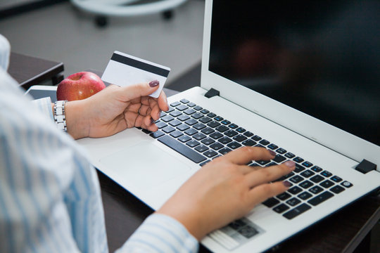 Online shopping, e-commerce, money transaction, internet business concept. Female businesswoman hold plastic credit card sit by laptop