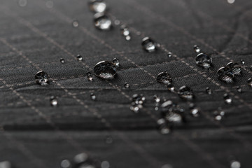 Rain Water droplets on  black waterproof fabric