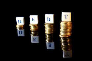 Stack of Golden Rupiah, Indonesia Coin, Illustration for Debt at Black Background with reflection at the bottom