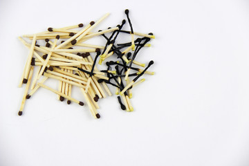 A bunch of burnt and whole matches on a white background