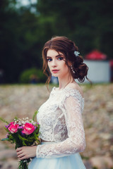portrait of beautiful bride in wedding dress outdoors