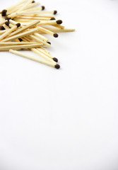 A bunch of burnt and whole matches on a white background