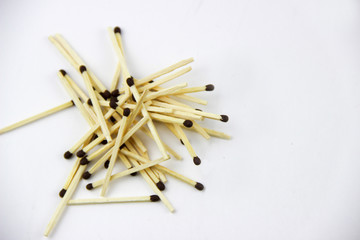 A bunch of burnt and whole matches on a white background