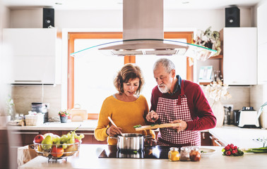 Senior couple preparing food in the kitchen.