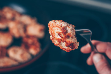 Cutlet on a fork, a man tries a cutlet, a first-person view