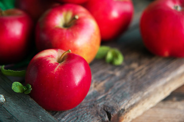 group of red apples on wooden natural background, fresh natural food and vitamins concept in rustic style