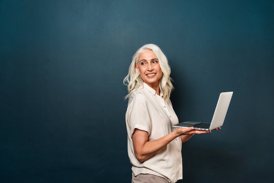 Cheerful Mature Old Woman Using Laptop Computer.