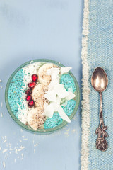 Breakfast blue spirulina smoothie bowls and chia pudding topped with fresh fruits