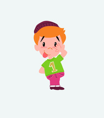 Hipster boy sticks out his tongue in gesture of funny shyness.