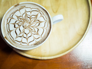 A cup of hot chocolate with milk froth.