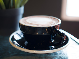 A cup of hot chocolate with milk froth.