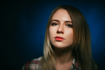 Fototapeta premium portrait smiling girl on blue background in studio