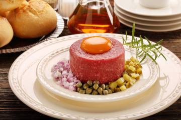 Beef steak tatare with egg, onion, cucumber and capers
