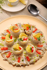 Rolled herrings with fish salad and lemon