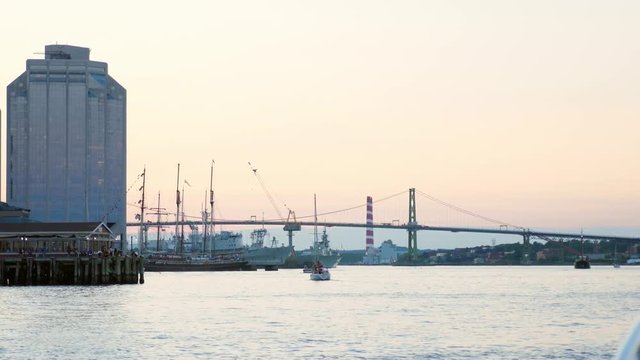 Downtown Halifax City Nova Scotia Canada with boats in harbor by bridge