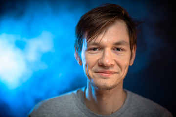 portrait emotional young man on blue background