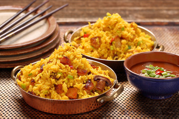Chicken with basmati rice fried in stainless pan