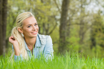 Woman laying on green grass