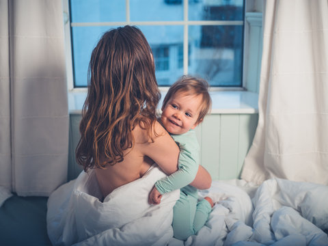 Mother embracing little boy in morning