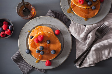 pancakes with blueberry raspberry honey and jam for breakfast