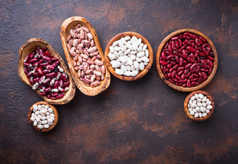 Assortment of various beans in wooden bowls 