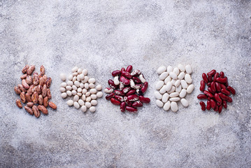 Assortment of various beans on light  background