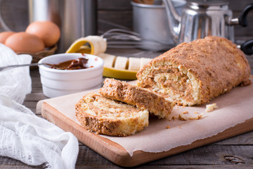 Homemade sweet biscuit roll with cream and banana