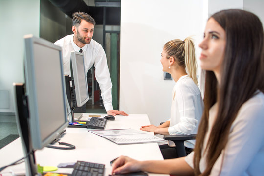 Busy Businessman In Office Reception Area Talking With Secretary