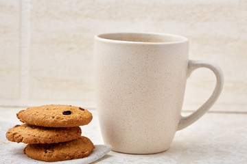 Close-up white cup of coffee with chocolate chip cookies on white background, top view