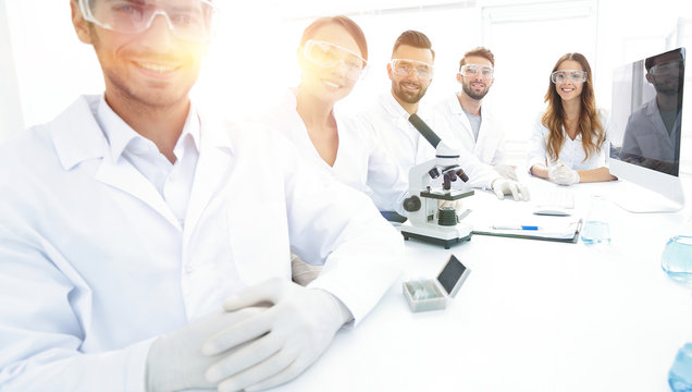 Male scientist and the team in the lab.