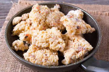 Pilaf in a frying pan. A dish of rice with meat.