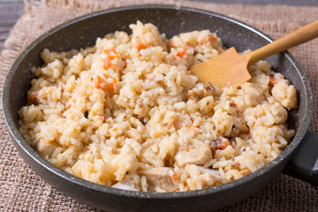 Pilaf in a frying pan. A dish of rice with meat.