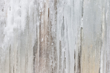 Frozen waterfall background. Wall texture from big icicles