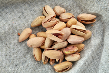 Pistachios on fabric cotton napkin, sallow depth of field, selective focus, top view, macro