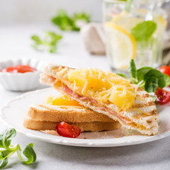 Hot fresh hawaii toast sandwich with ham, pineapple, tomato and cheese. Healthy summer food concept.
