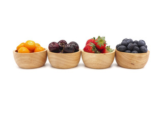 Fresh summer fruits, Cherry, strawberry, cape gooseberry and blueberry in wooden bowl isolated on white background.