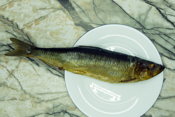 Fish dish cooking with various ingredients. Raw Sea bass with lemon, garlic, herbs and spices on...