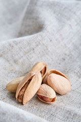 Pistachios on fabric cotton napkin, sallow depth of field, selective focus, top view, macro