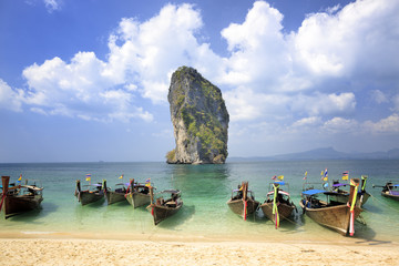 Typical Thai longtail boats Poda Island, Thailand. The longtail boats are used as water taxis to bring tourists to remote beaches or islands.