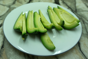 Avocado slices isolated on white eating exotic,