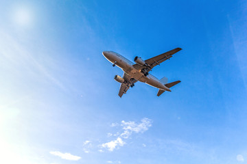 Flying aircraft with passengers over blue sky